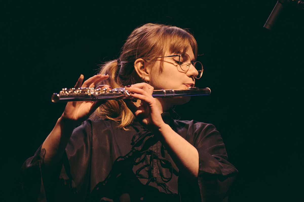 A flutist from Poland plays with an orchestra, 1st prize